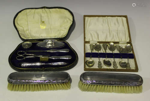 A George V silver mounted manicure set, comprising nail buffer, cylindrical pot, file, pair of