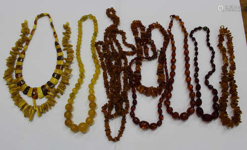 Nine various amber, reconstituted amber and imitation amber necklaces in a variety of designs.