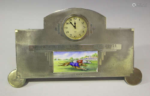 A George V silver trophy desk timepiece of shaped rectangular form with engine turned decoration,