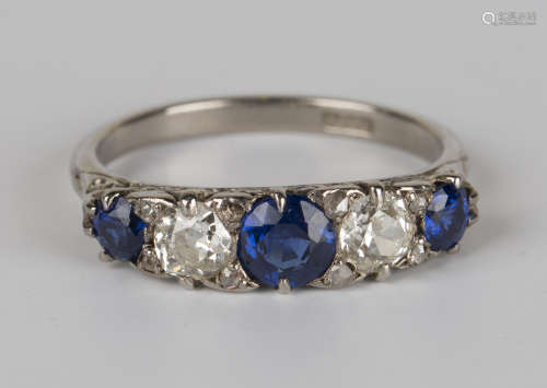 A white gold, sapphire and diamond five stone ring, mounted with three cushion shaped sapphires