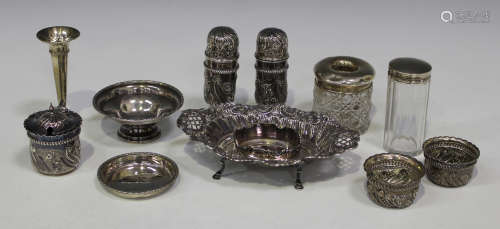 A pair of late Victorian silver cylindrical salt and pepper casters, each decorated in relief with