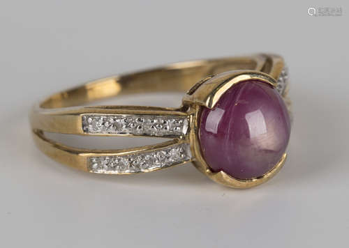 A 9ct gold ring, mounted with a star ruby to the centre between diamond set pierced shoulders,