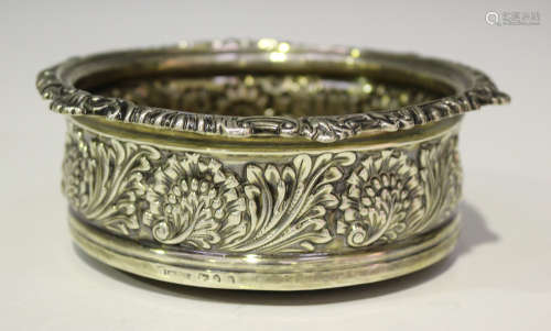 An early 19th century silver coaster, decorated in relief with stylized leaves, indistinct marks,
