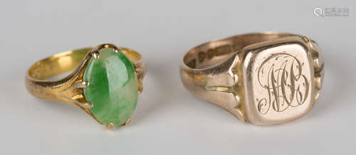 A Chinese gold ring, claw set with an oval jade, ring size approx J1/2, and a 9ct gold signet