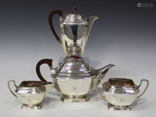 A George V silver four-piece tea set of octagonal tapering from, comprising teapot, hot water pot,