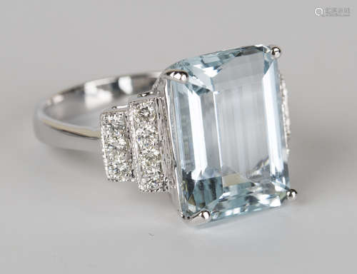 An 18ct white gold, aquamarine and diamond ring, claw set with a rectangular cut aquamarine