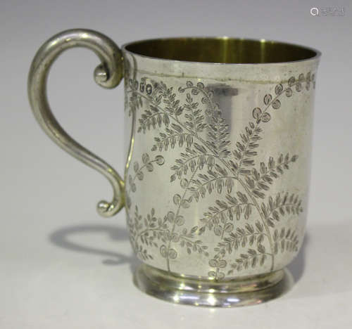 A Victorian silver christening mug, engraved with ferns, flanked by a scroll handle, London 1872