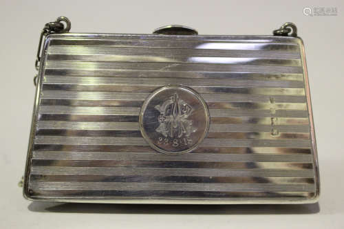 A George V silver mounted purse of tapering form with engine turned banded decoration, with a