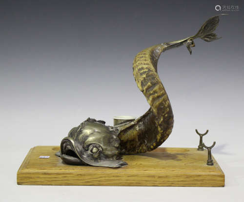 A Victorian plate mounted ram's horn inkwell in the form of a dolphin with raised tail and flukes,