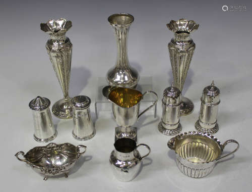 An Edwardian silver cream jug with reeded loop handle, circular foot and square base, Birmingham