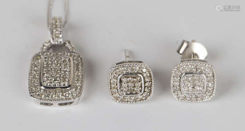 A white gold and diamond pendant of curved rectangular form, mounted with circular cut diamonds,