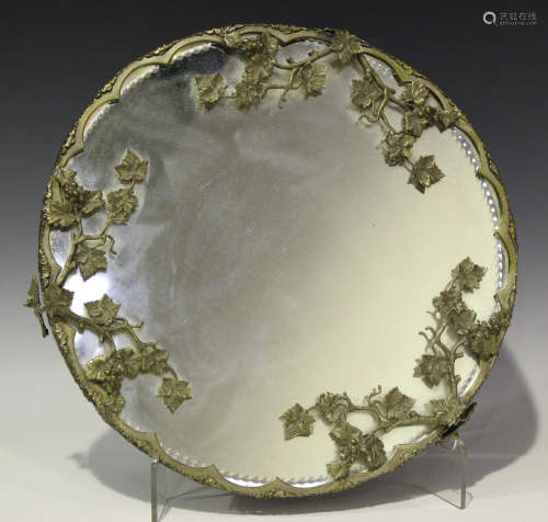 A late 19th/early 20th century plate mounted mirror plateau with cast and pierced vine border,