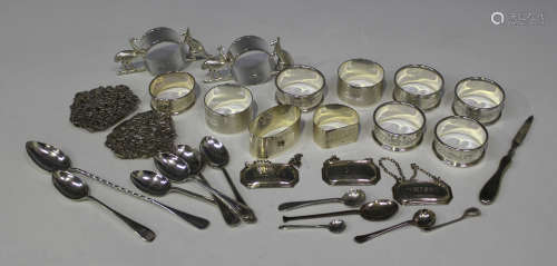 A group of ten various silver napkin rings, a silver two-section nurse's buckle, cast and pierced