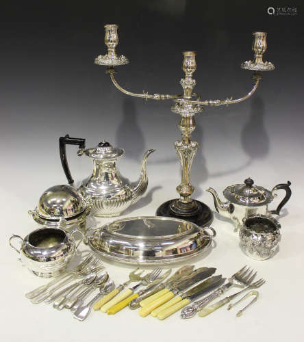 A collection of plated items, including a twin scroll branch candelabrum, a teapot, an entrée dish