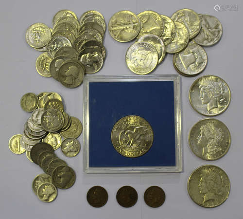 A collection of various USA coins, including three one dollar coins, 1890, 1923 and 1926, and a