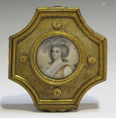 An early 20th century French gilt metal trinket box of shaped form, the lid inset with a glazed