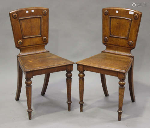 A pair of late Victorian oak hall chairs, on octagonal tapering legs, height 87cm, width 46cm.