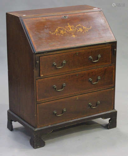 An Edwardian mahogany and inlaid bureau, the fall front above three long drawers, on bracket feet,