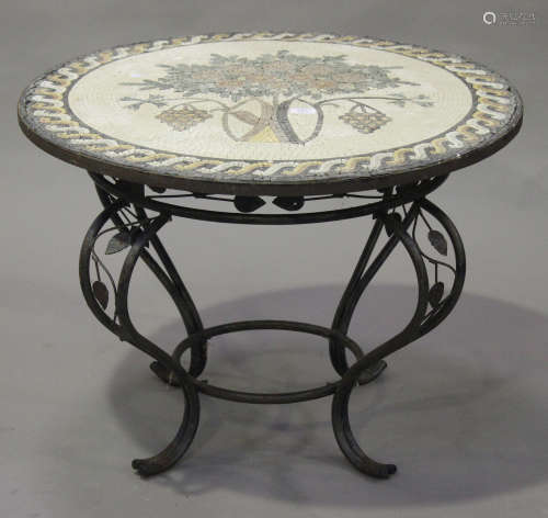 An early 20th century circular coffee table with mosaic top, on a wrought metal scrolling base,