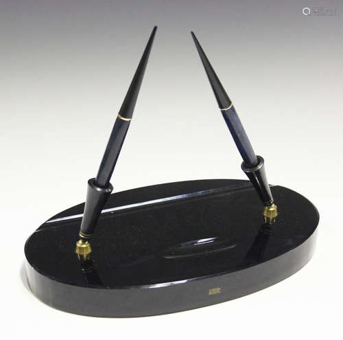 A Parker desk set, the signed black glass oval base fitted with a pair of adjustable sockets with