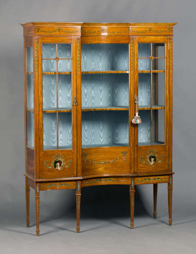An Edwardian satinwood and floral painted display cabinet, the inverted concave front fitted with