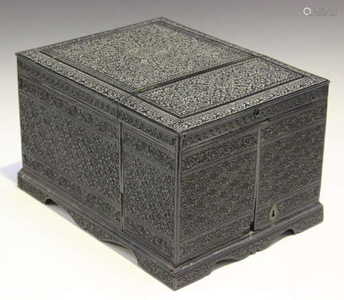 A 19th century Anglo-Indian carved ebony table-top dressing box, the exterior finely worked with