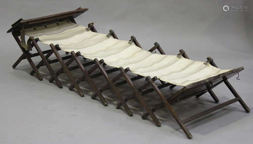 An early 20th century oak folding bed with canvas support, length 210cm.Buyer’s Premium 29.4% (