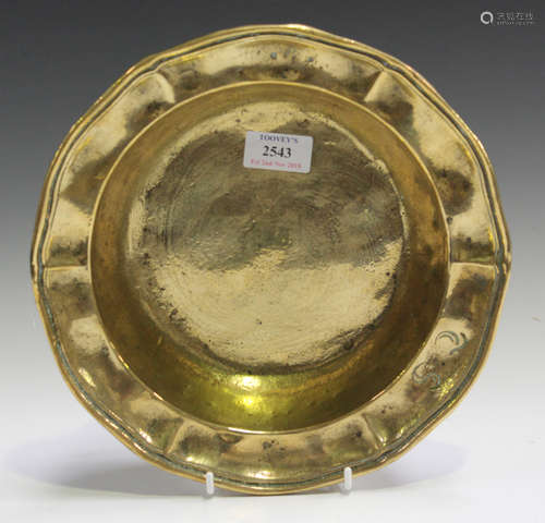 An 18th century Continental cast brass bowl, the raised sides with a shaped rim, diameter 26cm.