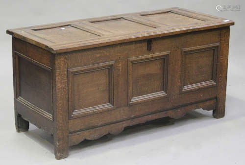 An 18th century oak coffer, the hinged lid above a triple panel front, on stile supports, height