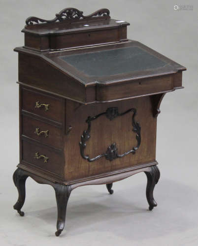 An Edwardian mahogany Davenport, fitted with a pen compartment above a hinged writing surface and