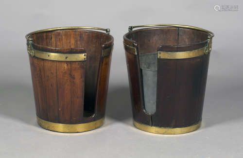 A near pair of George III Irish mahogany plate buckets, both fitted with brass swing handles and