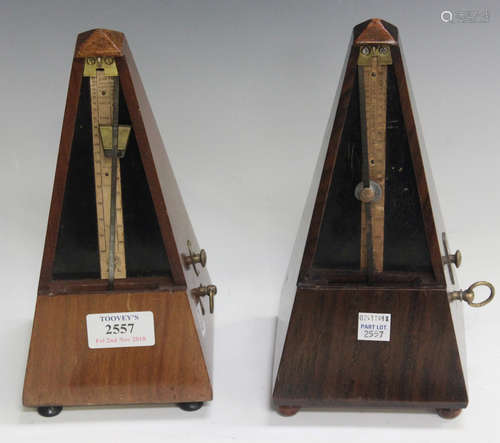 Two early 20th century walnut cased Maëlzel metronomes, both fitted with a bell, height 23cm.Buyer’s