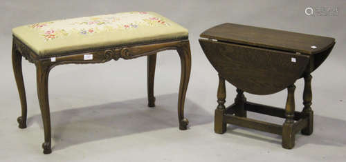 A 20th century reproduction beech stool with overstuffed tapestry seat, on cabriole legs, height