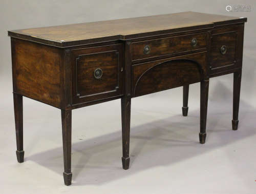 A George III mahogany breakfront sideboard, fitted with two drawers flanked by cupboards, on