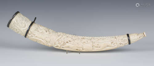 A fine 19th century carved ivory oliphant (hunting horn), decorated in relief with an oval profile