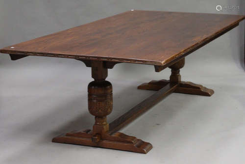 A 20th century Jacobean Revival oak refectory table, the rectangular top raised on cup and cover