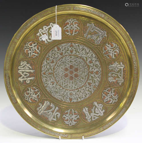 A late 19th century Cairo ware brass circular charger, profusely overlaid in silver and copper