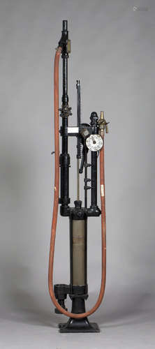 An early 20th century floor standing skeleton pump by Gilbert & Parker, with gallon dial, hose,