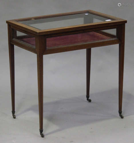 An Edwardian mahogany and satinwood crossbanded bijouterie table, the bevelled glass hinged top