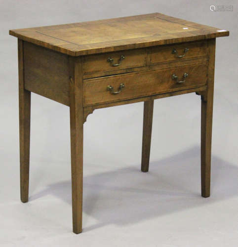 A George III provincial mahogany side table, the crossbanded top above three drawers, on block legs,