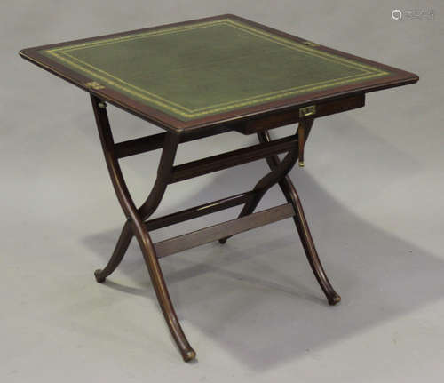 A Victorian mahogany coaching table with gilt-tooled green leather writing surface, on folding 'X'