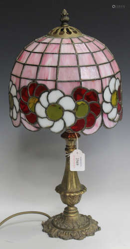 A late 20th century Tiffany style stained and leaded glass shade, raised on a cast brass base,