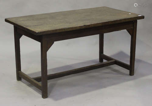 A 19th century provincial oak farmhouse kitchen table, the rectangular top raised on block legs