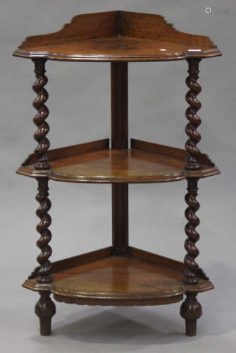 A mid-Victorian oak three-tier corner whatnot, the shaped gallery and moulded top raised on barley