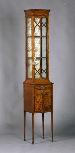 An unusual late Victorian Neoclassical Revival satinwood narrow glazed cabinet with tulipwood