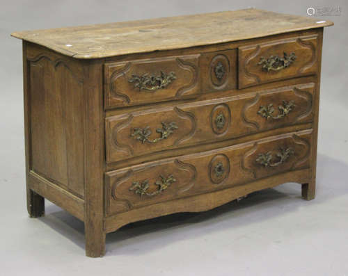 An 18th century French walnut serpentine fronted commode chest of two short and two long drawers, on