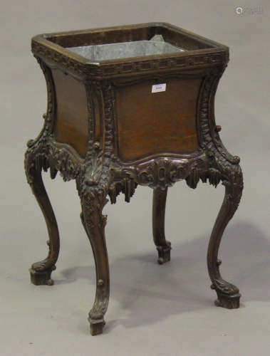 An early 20th century mahogany grotto style jardinière, the square body inset with a metal liner,