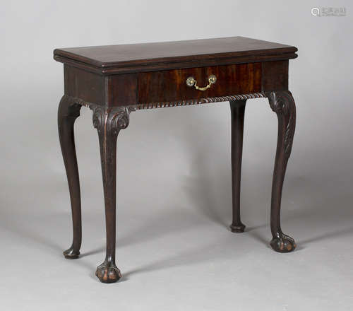 A George II mahogany fold-over card table, fitted with a single drawer, raised on carved cabriole