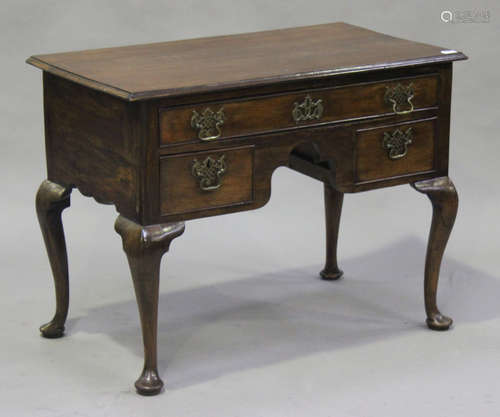 An 18th century and later walnut lowboy, fitted with three drawers, on cabriole legs and pad feet,