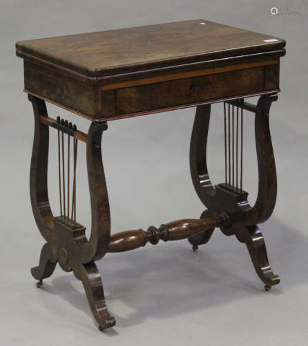 A mid-Victorian figured mahogany fold-over card table, fitted with a drawer raised on twin lyre